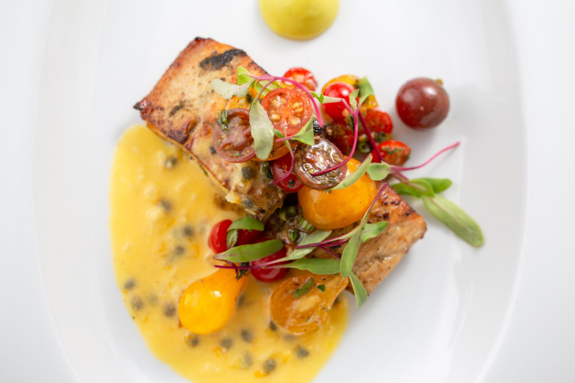 Seared Mahi-Mahi With Tomato Salad, Avocado Mousse, Passionfruit Beurre Blanc